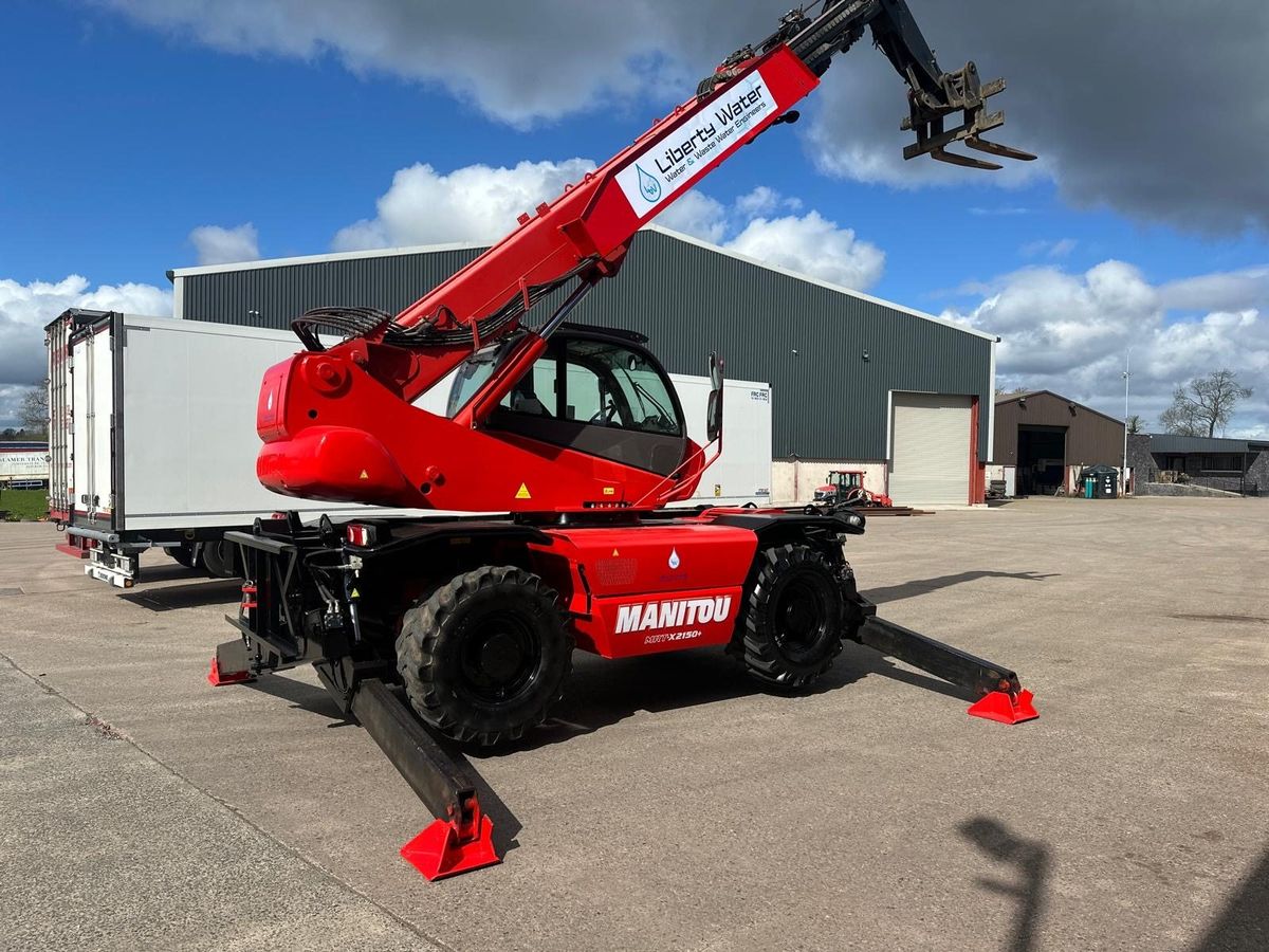 Liberty Water branded Manitou 2150 telehandler with fork attachment