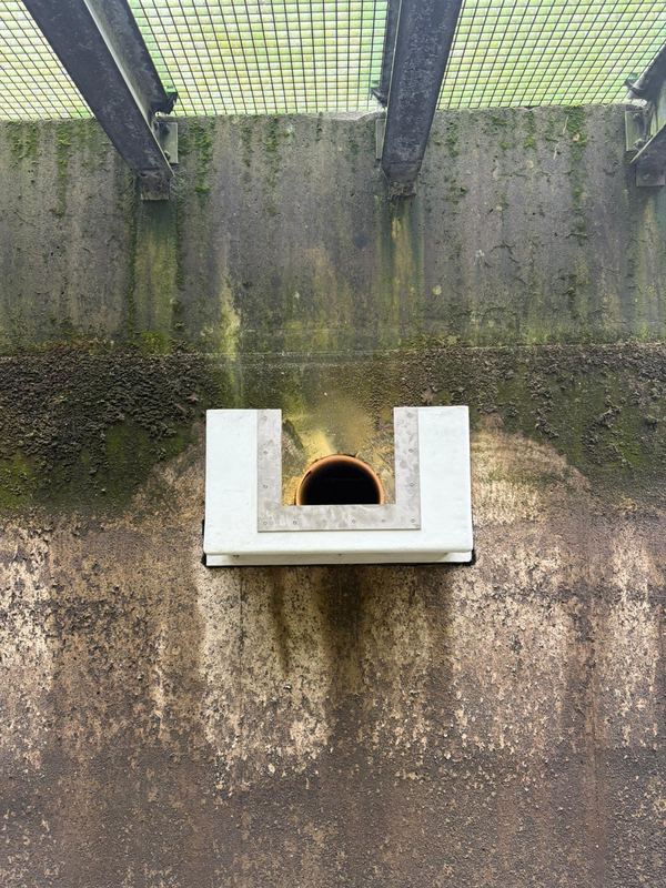 Front elevation of the stainless steel flow measuring weir plate on GRP box